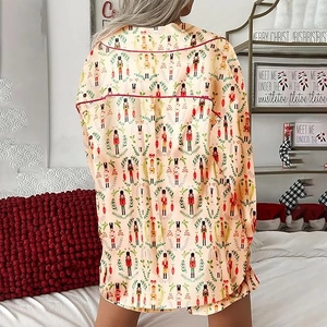 Rear view of Christmas pajamas featuring nutcracker prints and red piped edges