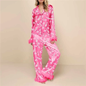 Detail of fuchsia satin pajamas with nutcracker print and faux fur trim on sleeves