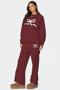 Détail de l'ensemble bordeaux avec imprimés nœuds blancs et pantalon ample décontracté