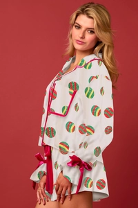 Dettaglio del set pigiama natalizio in raso con stampe festive e bordi in velluto