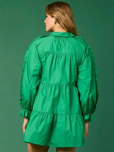 Back view of a tiered emerald green long sleeve mini dress with ruffle shoulder details