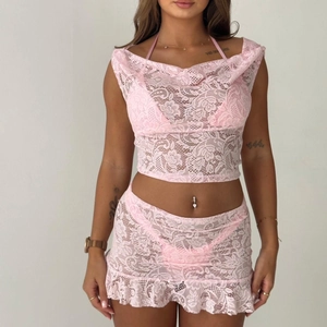 Detail of pink floral lace two-piece set featuring sheer mesh texture and ruffled hem