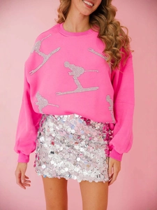 Pink crewneck sweatshirt with silver rhinestone skier motifs and sequin skirt outfit