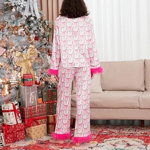 Pink satin Christmas pajama set with plush faux fur trim and Santa Claus prints
