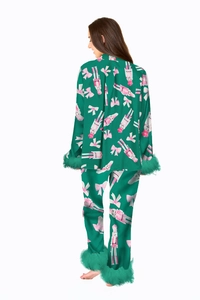Detail view of green satin pajama set back with pink nutcracker print and faux fur trim