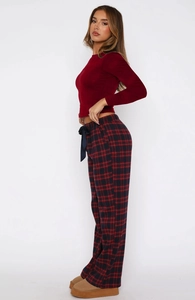 Detail view of red long sleeve slim-fit top and red-black checkered trousers set