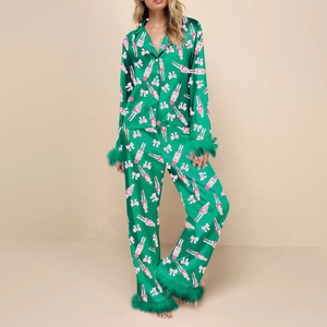 Detail of Christmas green satin pajama set with pink nutcracker print and feather trim