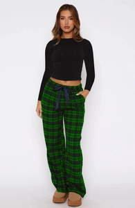 Detail of green plaid pajama pants with a navy satin drawstring bow and crop top