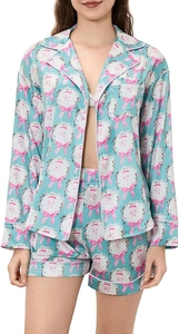 Detail of Christmas pajamas set showing blue satin shirt and shorts with Santa print