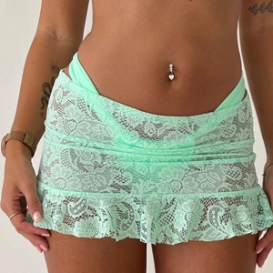 Detail of mint green floral lace skirt with ruffled hem and matching bikini set