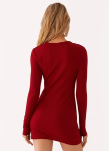 Rear view of a slim-fit dark red ribbed long-sleeve dress showing detailed fabric texture