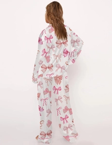 Rear view of a white satin pajama set featuring cute pink bow patterns and a loose fit