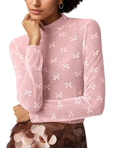 Close-up of pink sheer lace top with intricate bow patterns and mesh dot texture