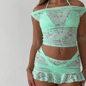 Detailed close-up of mint green lace three-piece set with intricate floral patterns