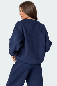 Side view of navy blue crewneck sweatshirt and wide-leg jogger set in soft knit fabric