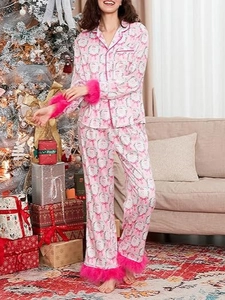 Women's pink satin Christmas pajama set with Santa prints and pink faux fur trim