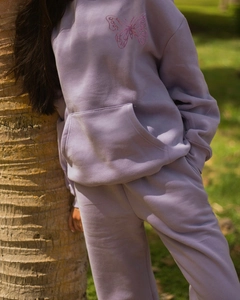 Detail view of pink butterfly embroidery on light purple fleece hoodie and joggers