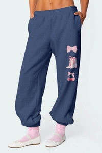 Detail of navy joggers with coquette pink bow and cherry print on the leg