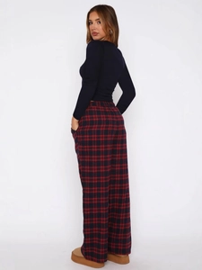 Women's casual outfit with black slim long sleeve top and red plaid wide-leg trousers