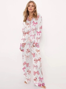 Women's two-piece pajama set with pink bow print on silk-like long sleeve top and pants