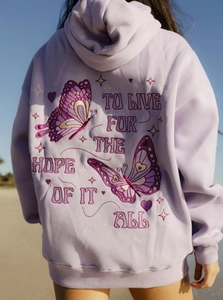 Detail of lavender oversized butterfly hoodie with back embroidery on a sunny beach