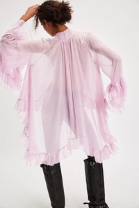 Detail view of tiered ruffles on lavender sheer chiffon blouse with trumpet sleeves