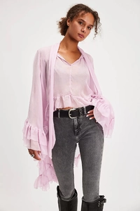 Detail of lavender sheer blouse with elegant flare sleeves and delicate lace-up design