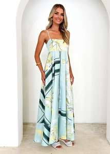 Detailed macro shot of light blue floral print and green geometric patterns on summer maxi dress