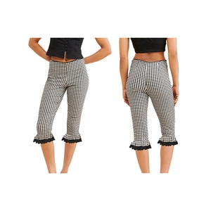 Detail of gingham cropped pants featuring ruffled hem and black lace trim for women