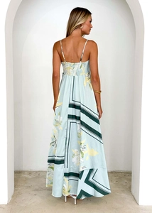 Detail view of back shirred elastic waist on a light blue floral backless maxi dress