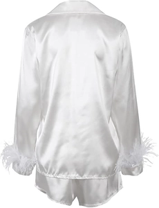 Detail view of white satin pajamas with elegant feather trim on the sleeve cuffs