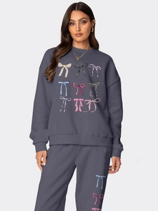 Women's dark grey sweatshirt and sweatpants set with colorful butterfly bow prints