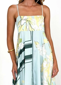 Detail of light blue floral dress with thin straps and smooth satin fabric texture
