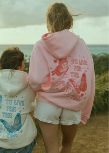 Close-up of butterfly embroidery and motivational text on oversized hoodies back