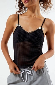 Detailed close-up of polka dot camisole featuring delicate satin bows and thin straps
