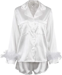 Detailed view of white satin pajama set featuring luxurious feather trims on sleeves