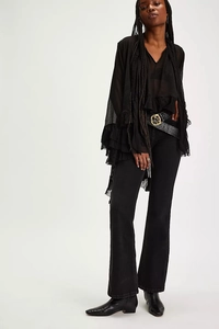 Detail of sheer black tiered chiffon blouse with bell sleeves and textured ruffles