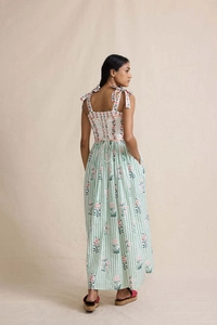 Detail of bohemian maxi dress showing tie-up shoulder straps and pink floral stripe pattern
