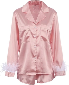 Detailed view of pink satin pajama set with luxury feather trim on the shirt sleeves