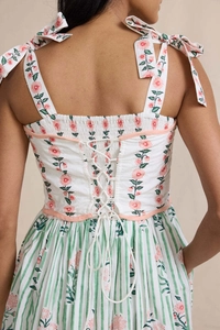 Close-up of bohemian floral dress featuring lace-up back and adjustable ribbon straps