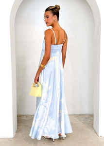Close-up of back elastic smocking and white floral print on a light blue summer dress