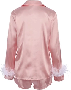 Pink satin pajama set featuring long sleeve top with white feather cuffs and matching shorts