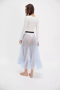 Detail of light blue tiered mesh skirt with white heart prints and black elastic waistband