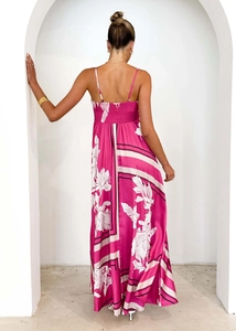 Detail of fuchsia floral maxi dress featuring a stretchy ruched back and silky fabric