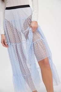 Detail of light blue mesh tiered skirt with white heart pattern and black elastic waistband