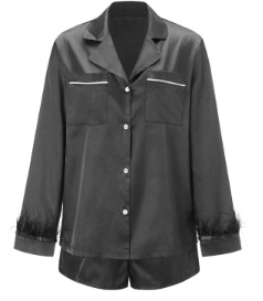 Detail of black satin pajama top showing feathered cuffs and button-down pocket design