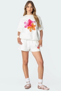 Détail d'un ensemble blanc décontracté avec imprimé floral et short à cordon serrage