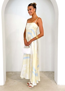 Detailed texture of silky satin floral sundress with thin straps and abstract print
