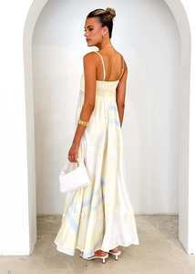 Close-up of backless floral dress featuring shirred elastic detail and thin straps
