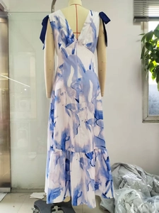 Detail view of abstract blue print maxi dress with deep V-back and navy ribbon bow accents